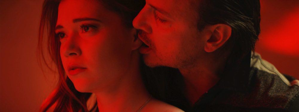 Two actors of the shortfilm elenore performing an act of prostitution in a red light room.