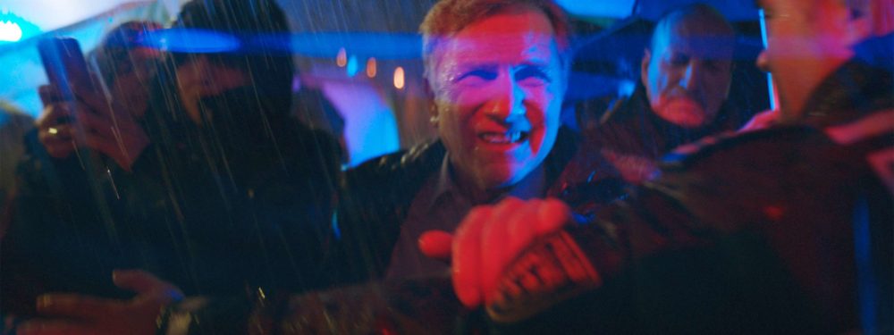 The father of elenore running through a crowd and getting blocked by police.