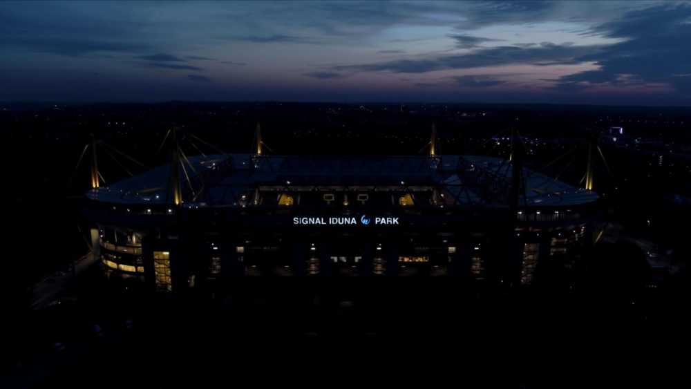 A wide shot of the Signal Iduna Park, the stadium of the football club Borussia Dortmund at night.