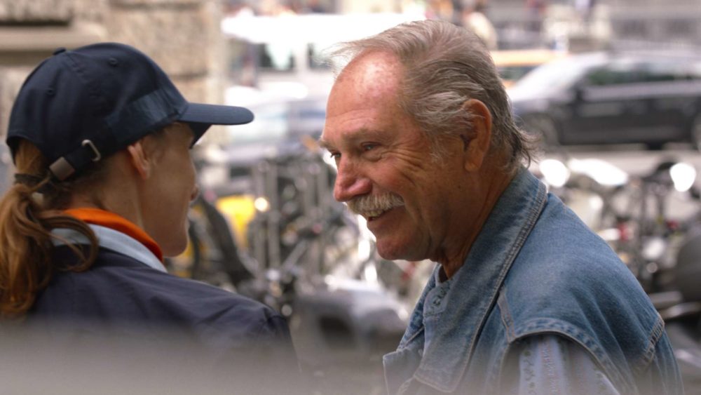 A person talking to the main actress of the commercial Twint Parking in front of bicycles in zurich.