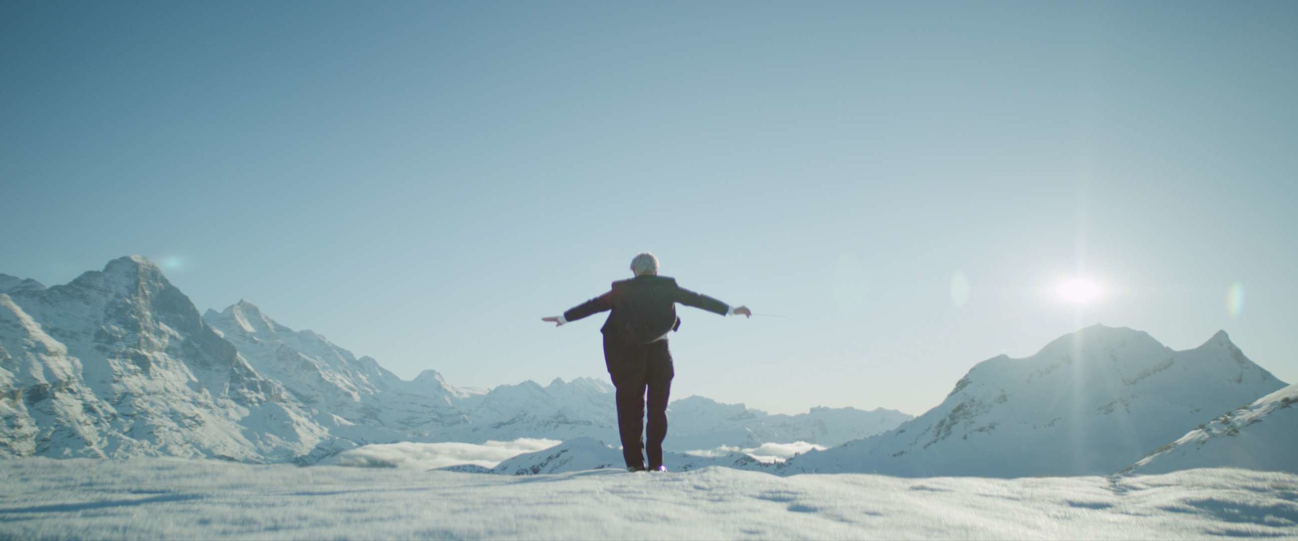 The conductor ending a beautiful piece on top of the mountain. VFX by Adrian Weber.
