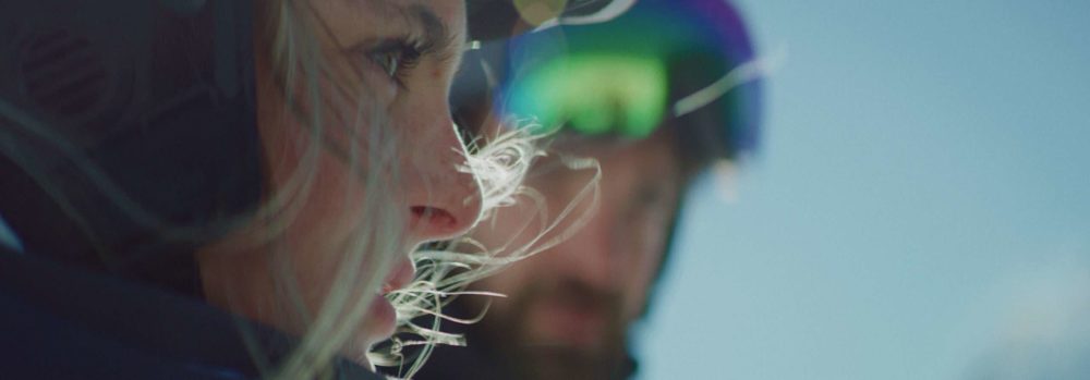 Two skiers looking over the valley on a perfectly blue winter day in Bern.