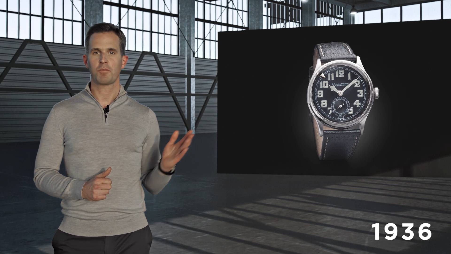 Christopher Grainer Herr, the CEO of IWC, pointing at a watch in a hangar.