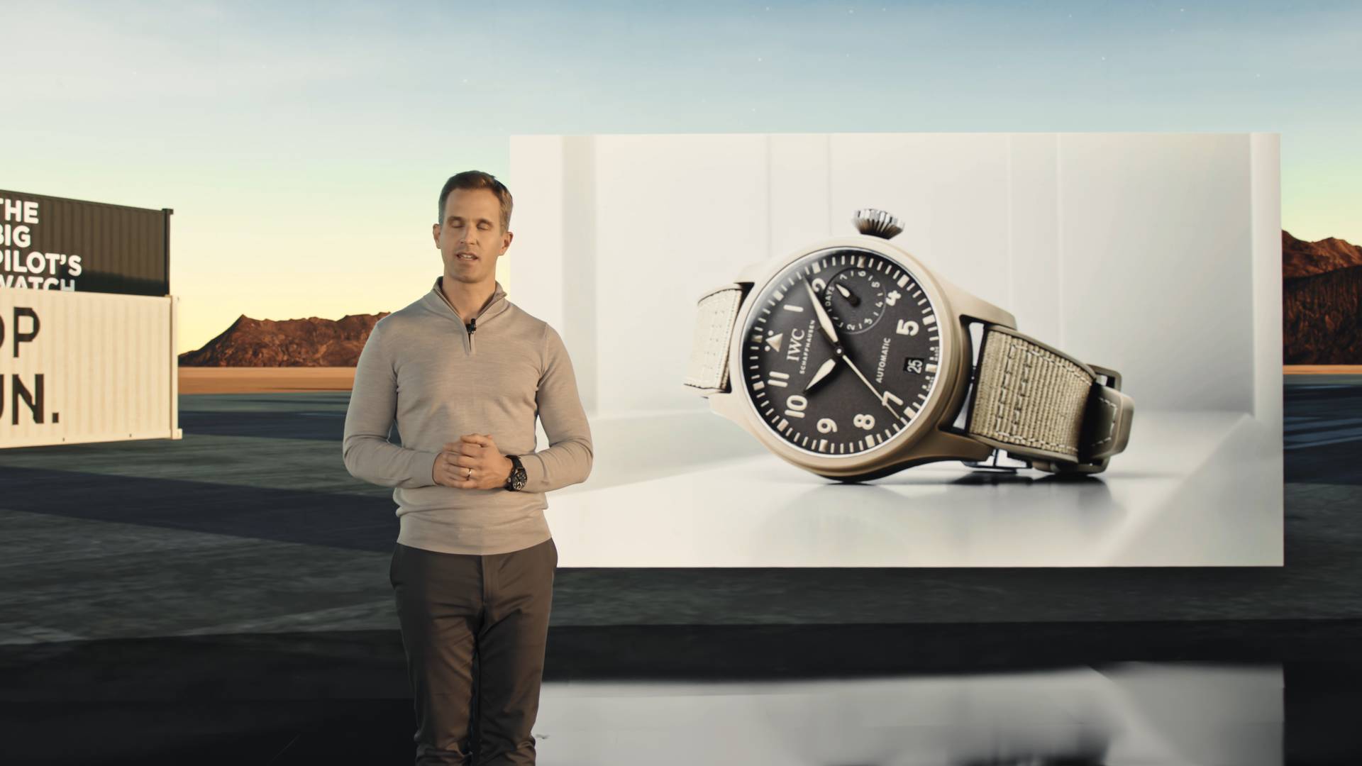 Christopher Grainer Herr standing in front of a billboard with a watch.