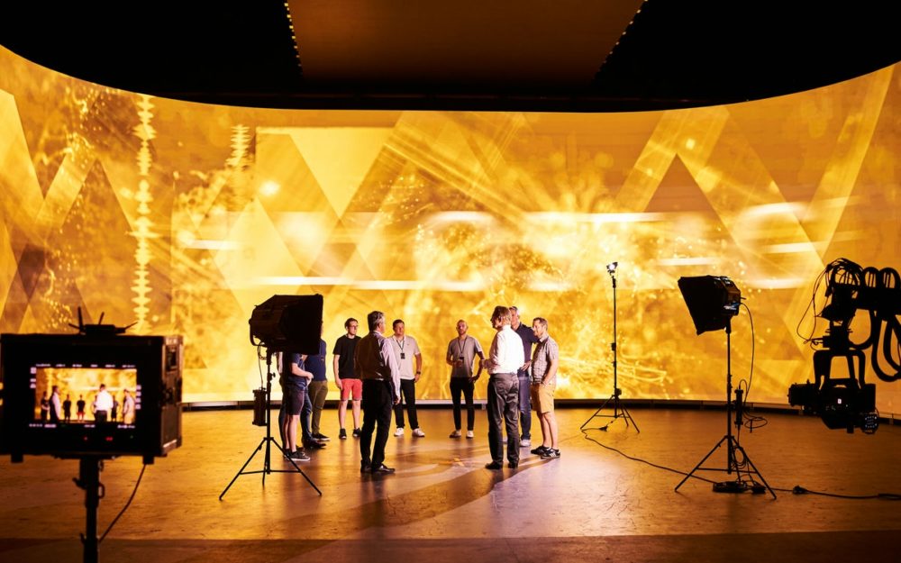 A couple of crew members of the Halostage standing in front of the LED wall.