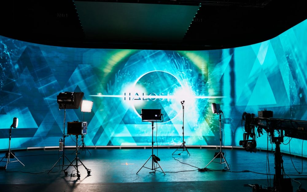 The Halostage in Babelsberg with a blue background and a camera crane and some lights, all setup and operated by Adrian Weber.