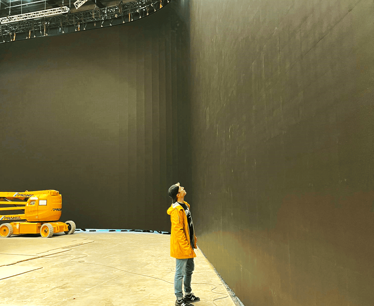 Adrian Weber standing in front of the massive ICVFX LED Wall he built for Poor Things in Budapest, filmed by Robbie Ryan, with Emma Stone and Mark Ruffalo