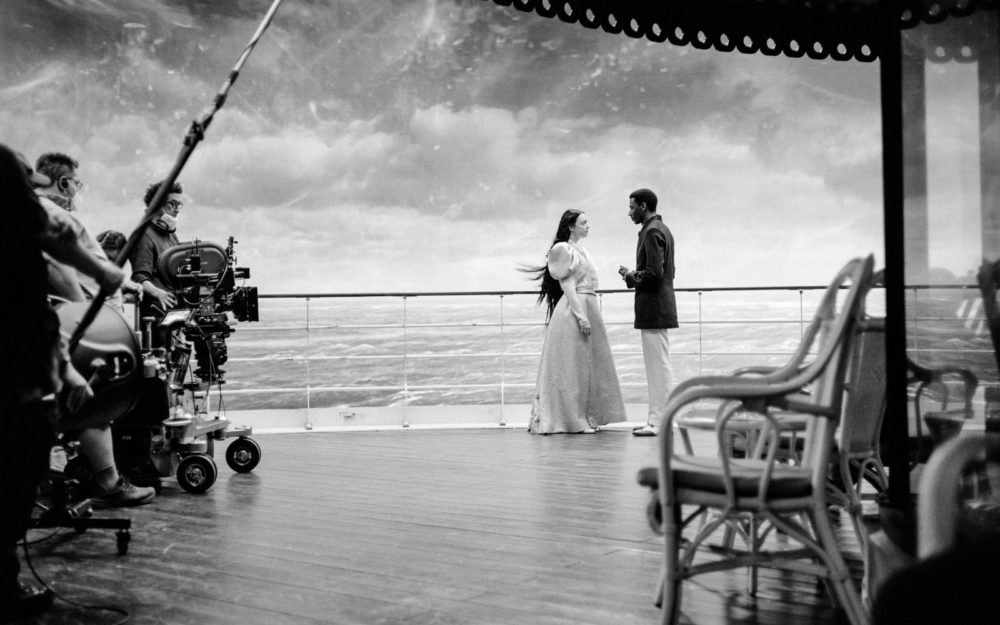 Robbie Ryan, Emma Stone and Ramy Youssef on the set of Poor Things in Budapest in front of the LED wall built by Adrian Weber with the content provided by Union VFX.