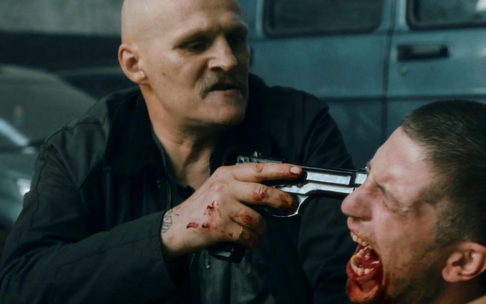 Two gansters treatening a victim with a gun for the Netflix Series